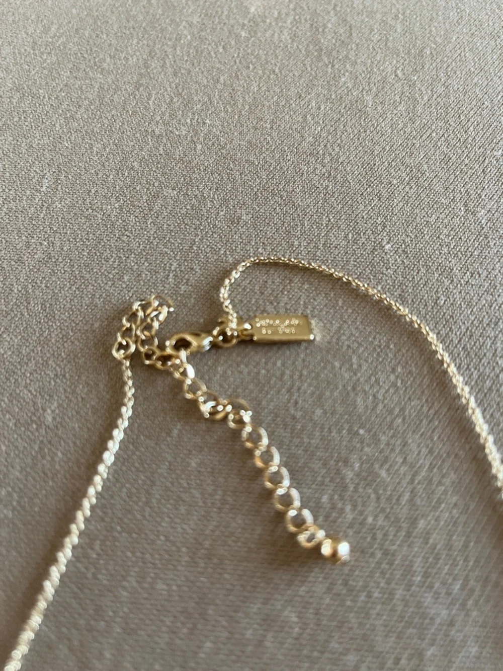Kate Spade long golden necklace with crystal beads.